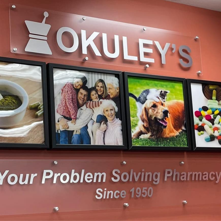 A pharmacist sitting down with a patient at Okuley's Pharmacy