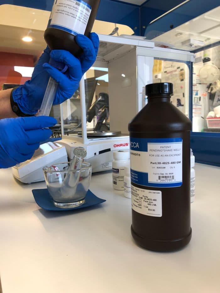 Pharmacist preparing custom compounded medication in the Defiance lab